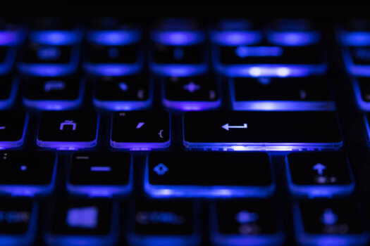 Closeup of laptop keyboard illumination, backlit keyboard. Blue light